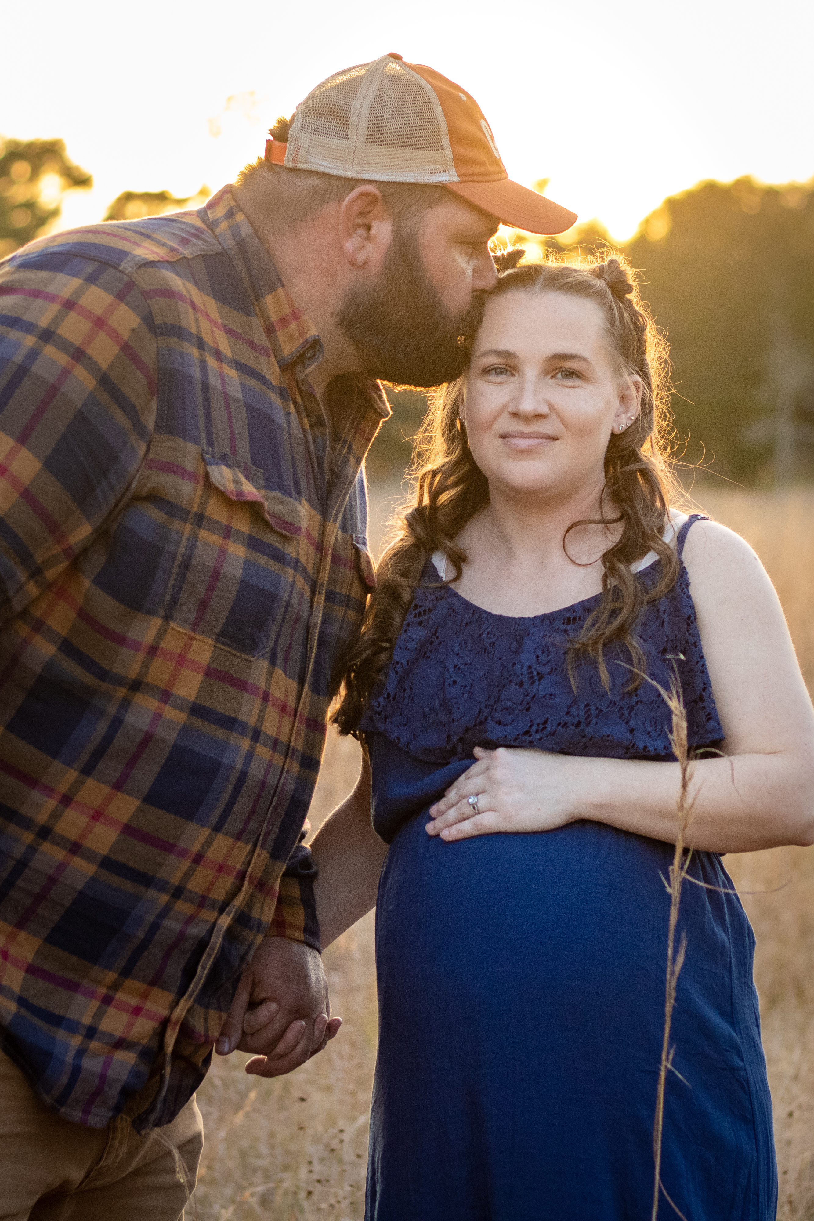 Girl standing by a fence. 